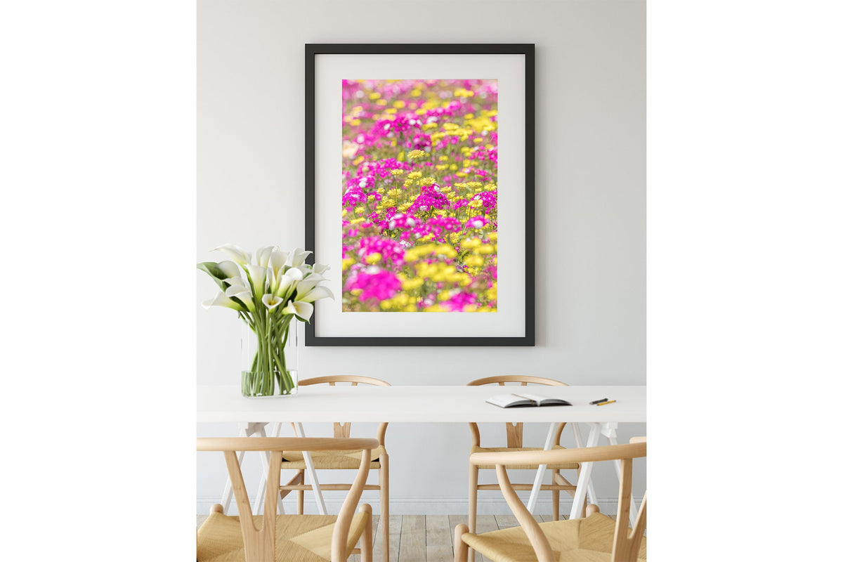 Pink and yellow meadow print shown framed in black.