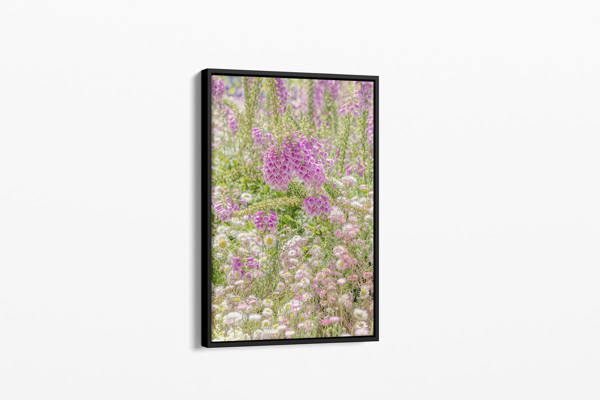 Foxglove meadow print shown as a canvas in a black float frame.