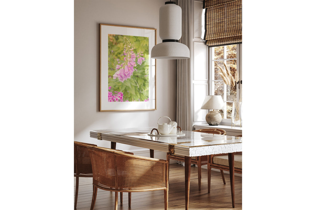 Foxglove bells print shown framed in oak above a dining table.