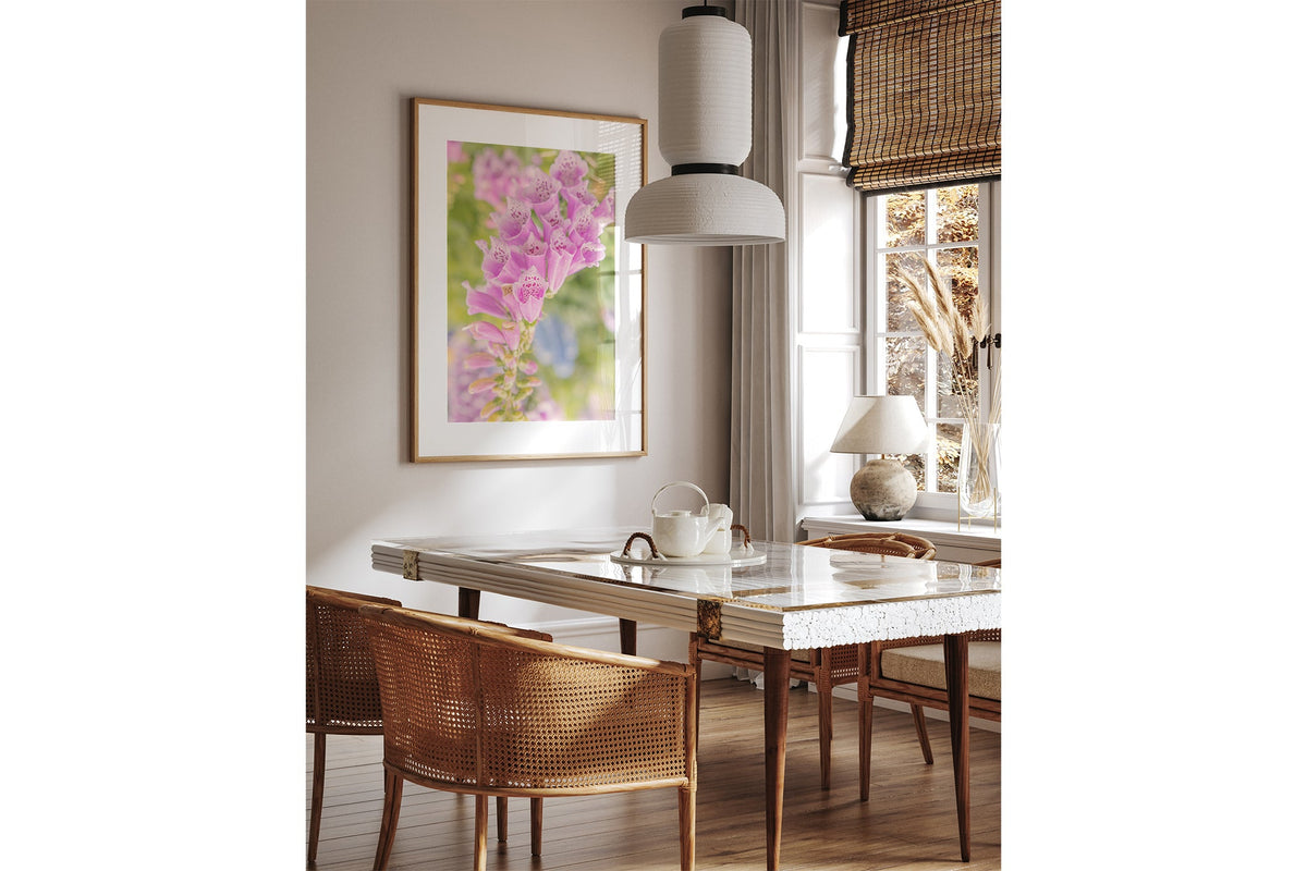 Spotted foxglove print shown framed in oak above a dining table.