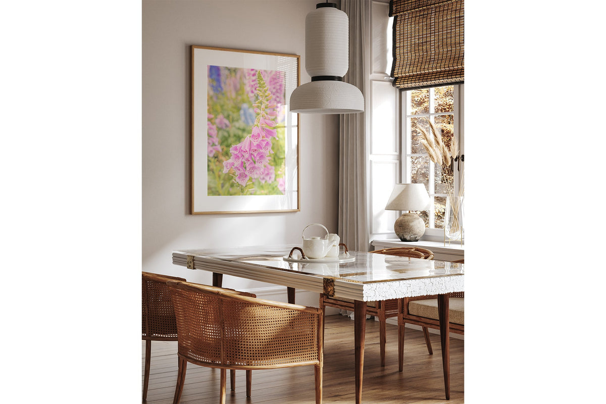 Cascading foxglove print shown framed in oak above a dining table.