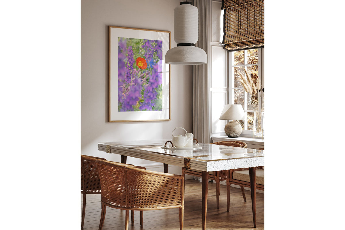 Poppy in larkspur print shown framed in oak above a dining table.