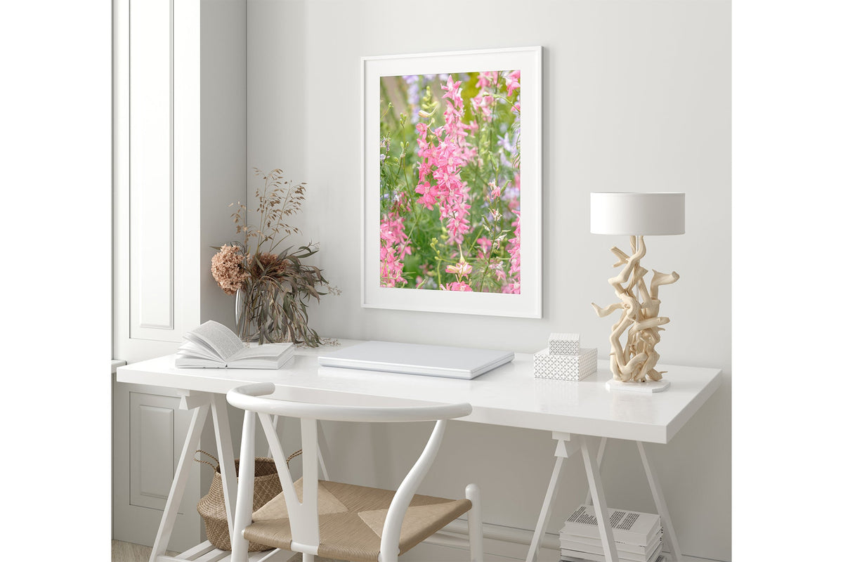 Pink larkspur print shown framed in white.
