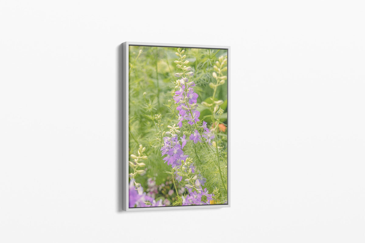 Lilac larkspur print shown as a canvas in a white float frame.
