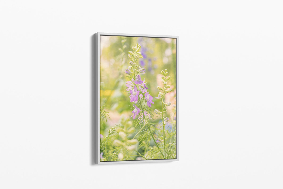Glowing larkspur print shown as a canvas in a white float frame.