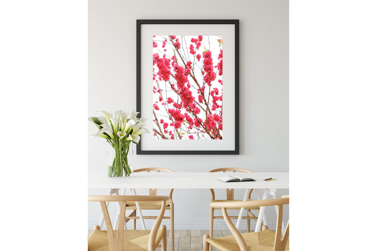 Crimson blossom print shown framed in black.