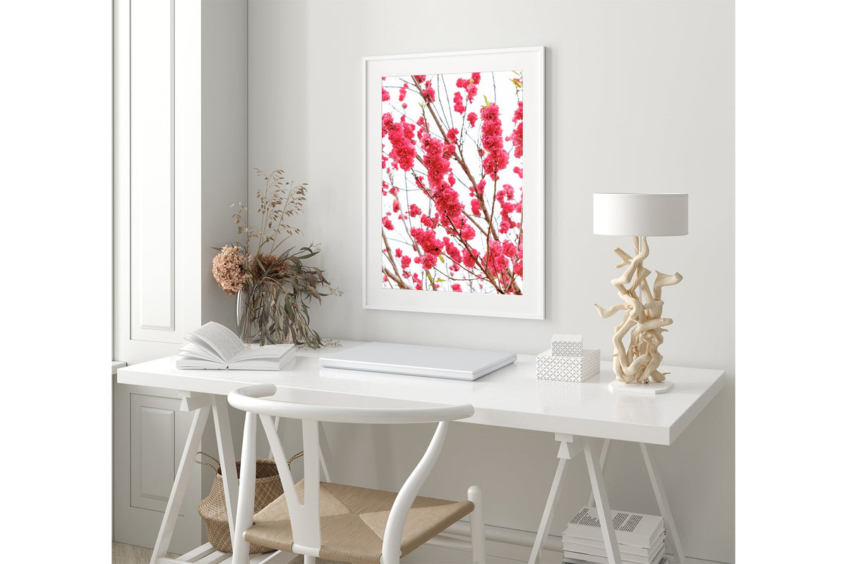 Crimson blossom print shown framed in white.