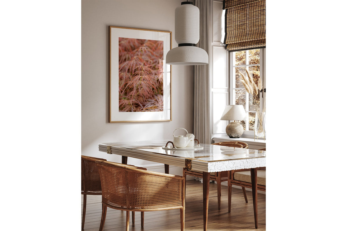 Japanese maple print shown framed in oak above a dining table.