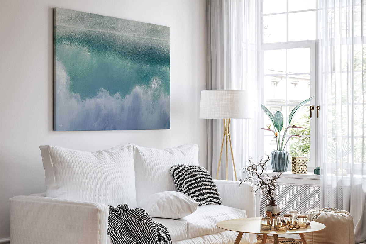 Aqua wave print shown as a canvas print in a white room.