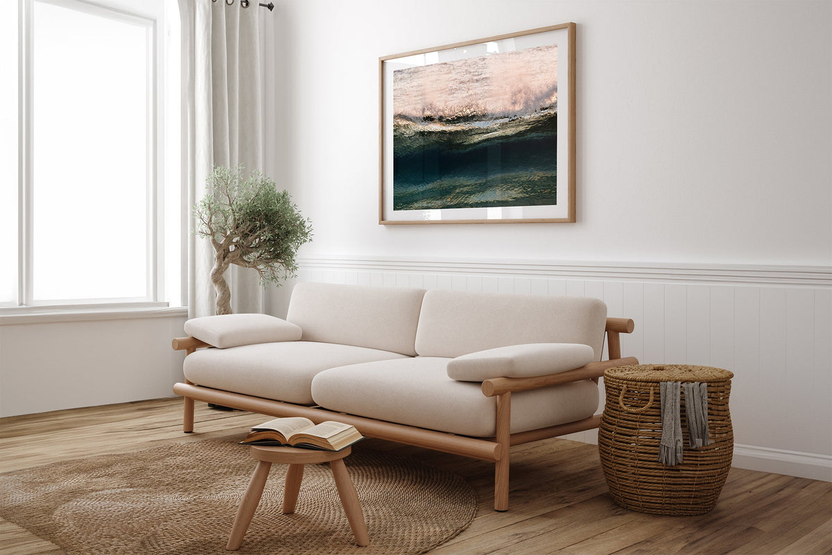 Rose Crest print shown framed in oak above a linen couch.