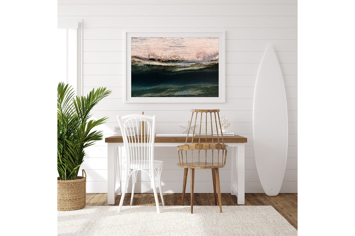 Rose Crest print shown framed in white on a white shiplap wall with a surfboard leaning beside a desk.