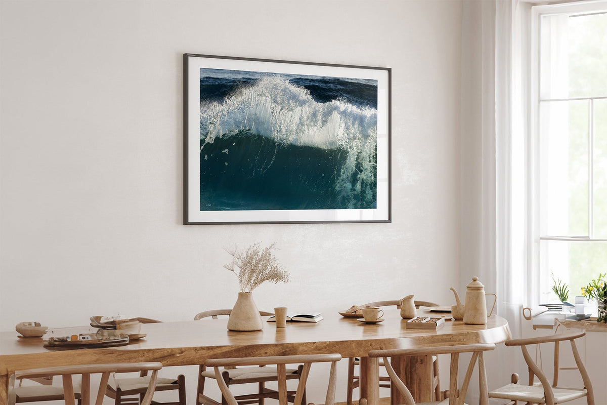 Glacier Crest print shown framed in black above an oak table.