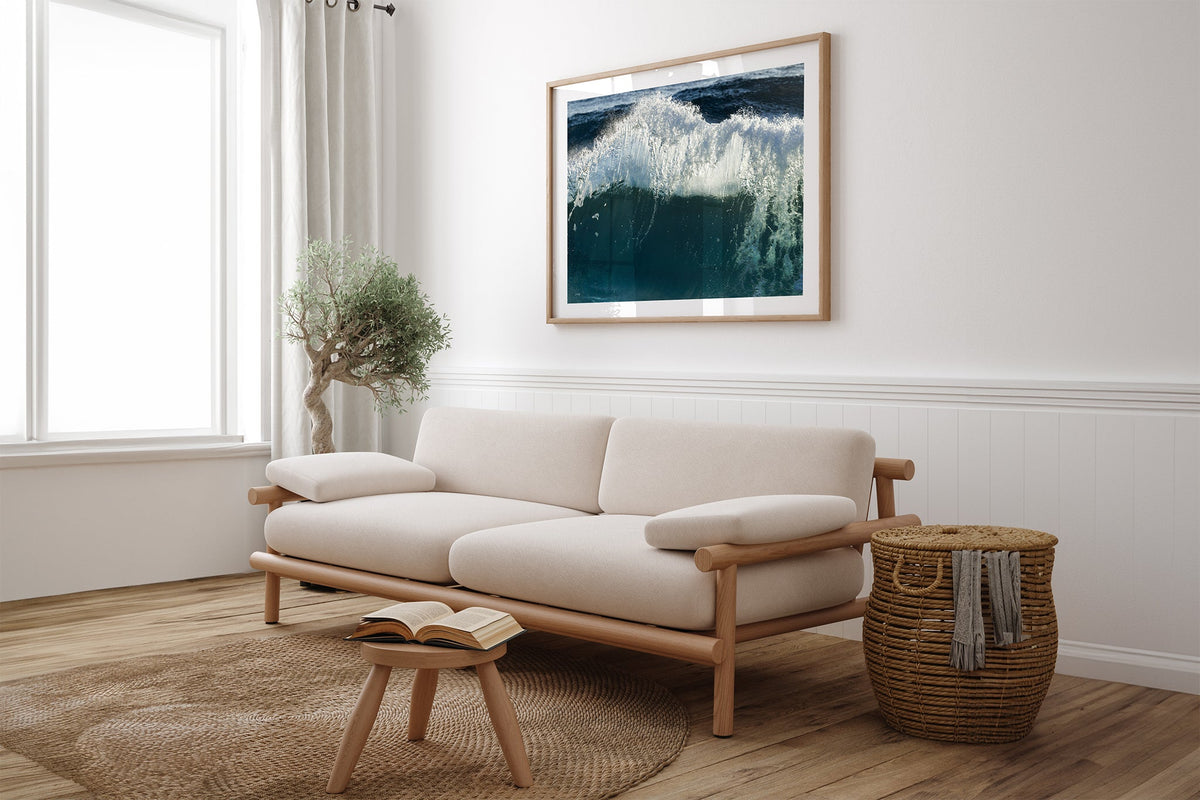 Glacier Crest print shown framed in oak above a linen couch.