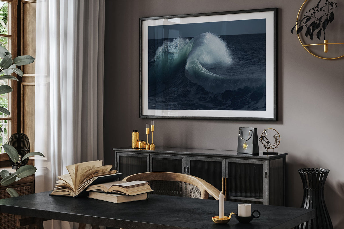 Moonlit Curl print shown framed in black in a dark room.