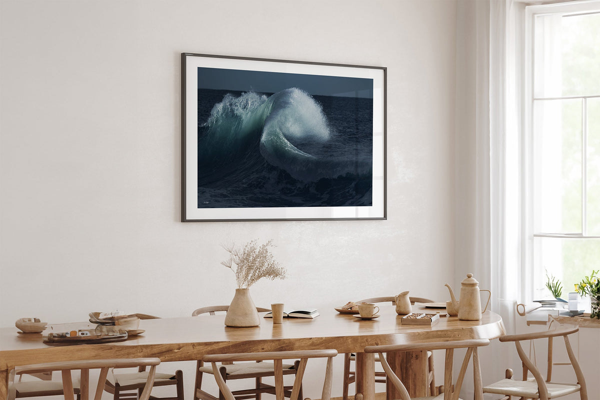 Moonlit Curl print shown framed in black above an oak table.