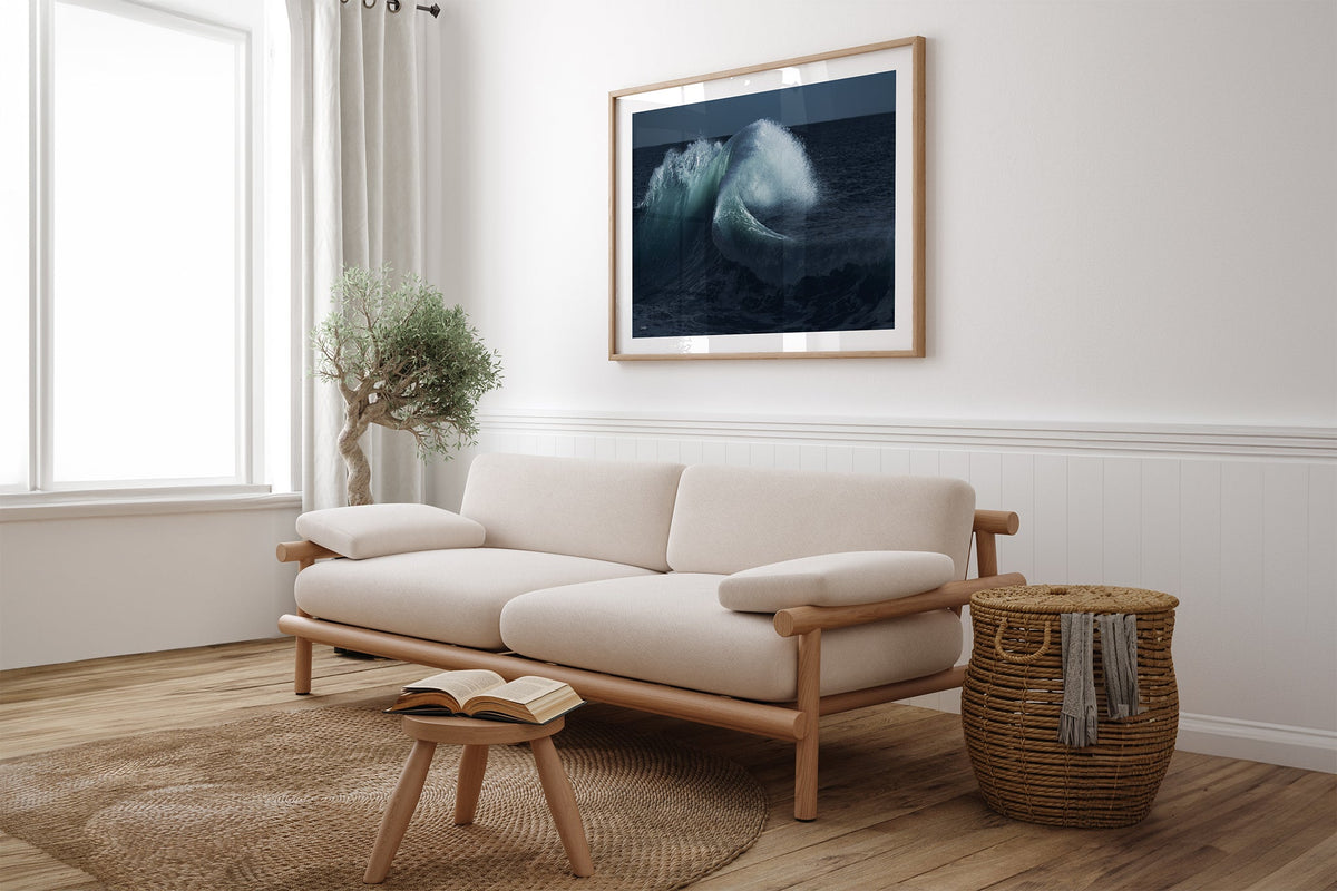 Moonlit Curl print shown framed in oak above a linen couch.