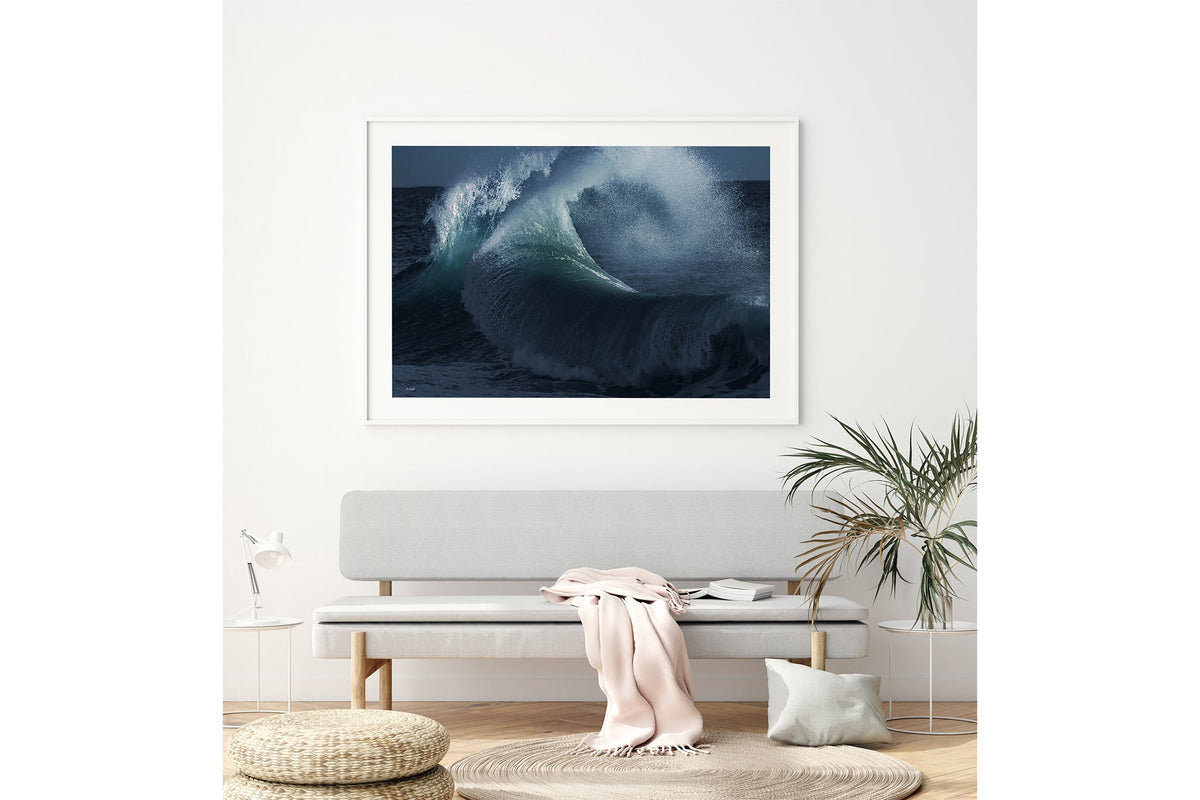 Rising Surge print shown framed in white above a bench seat.