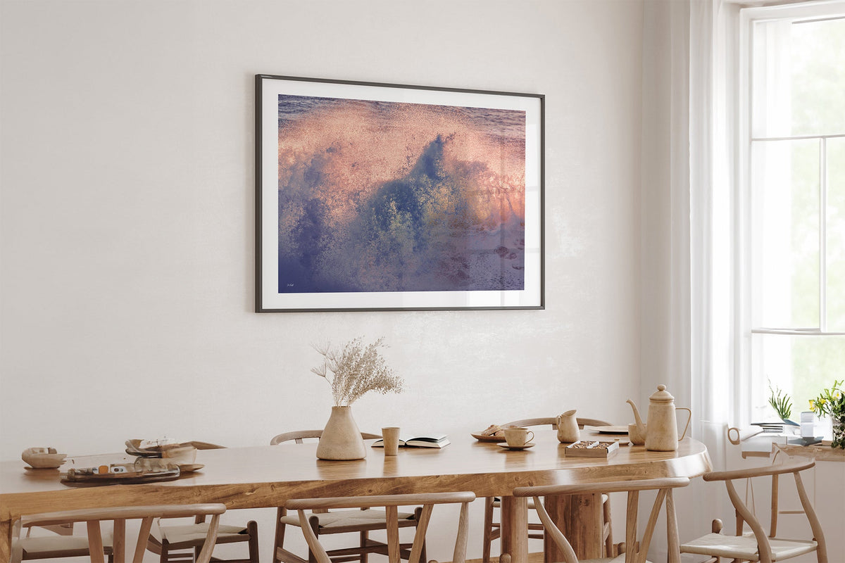 Dusk Burst print shown framed in black above an oak table.