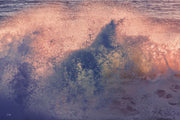 Pink, peach and gold spray bursting across the frame with patches of deep blue and violet, an abstract ocean wall print.