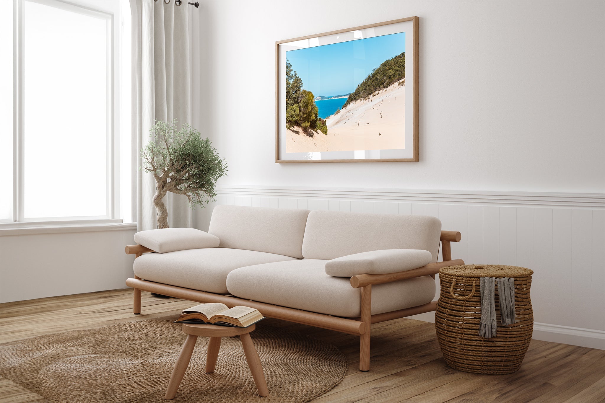 Rainbow Beach dune print shown framed in oak above a couch.