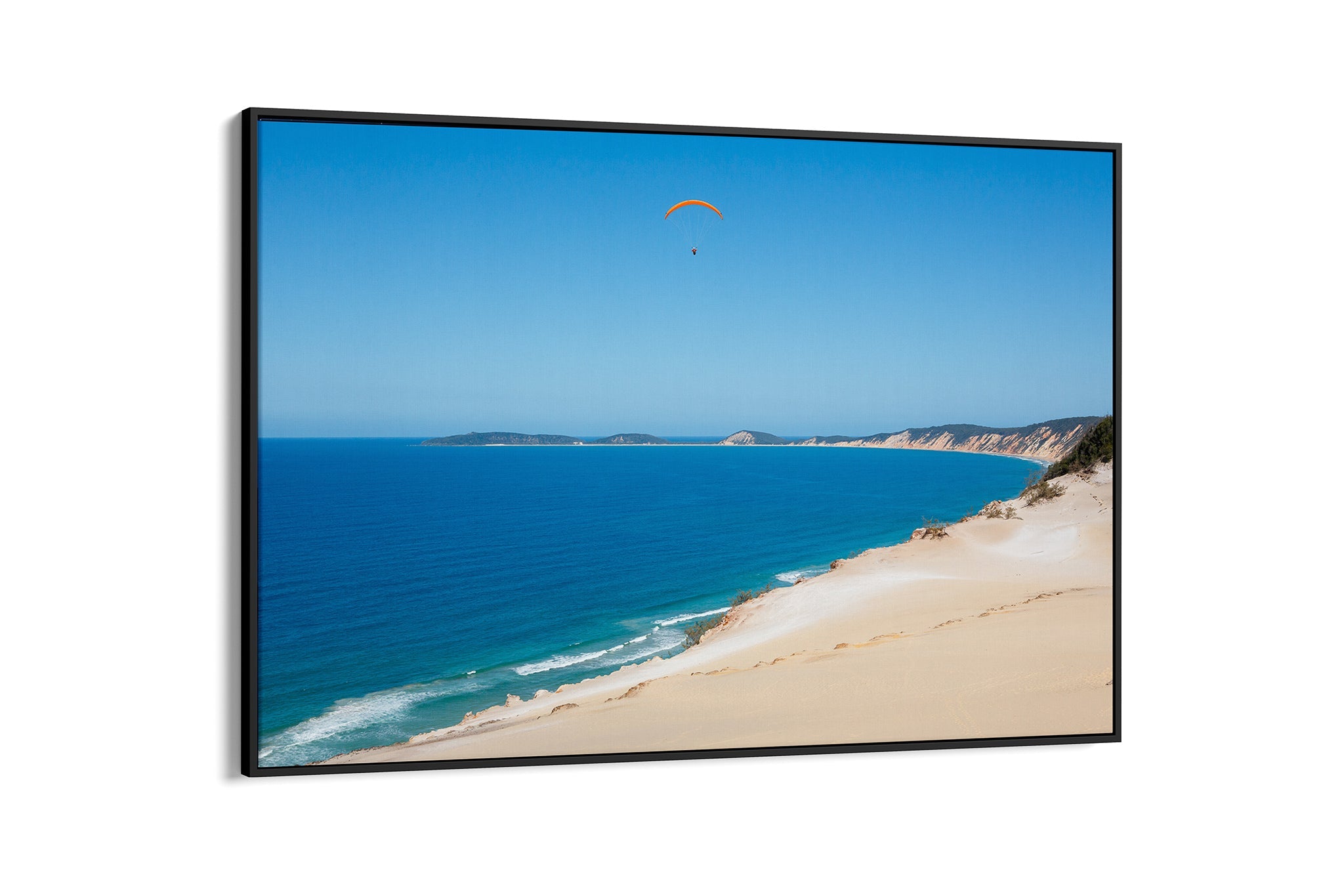 Rainbow Beach paraglider print shown as a black float frame canvas.