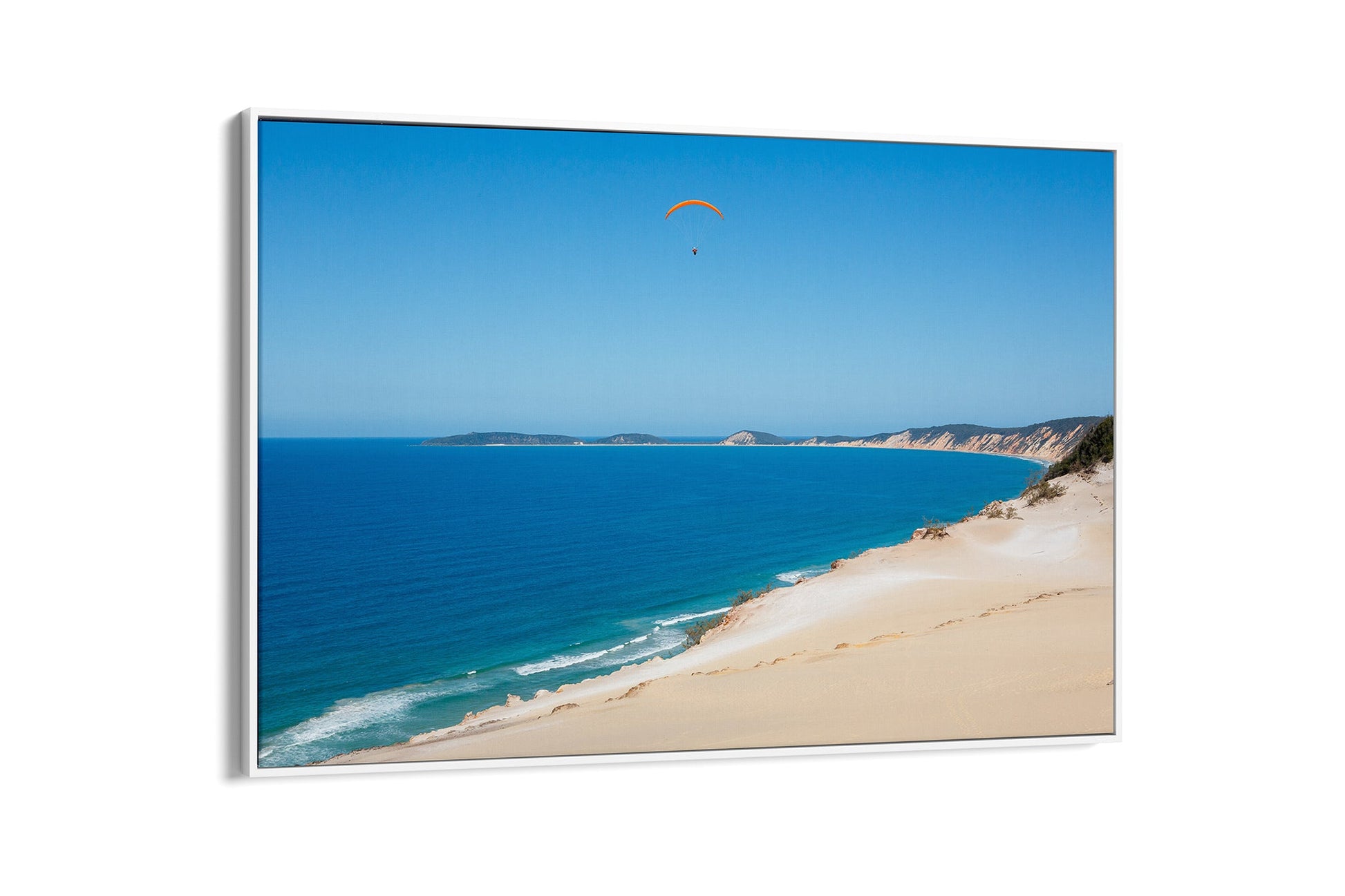Rainbow Beach paraglider print shown as a white float frame canvas.