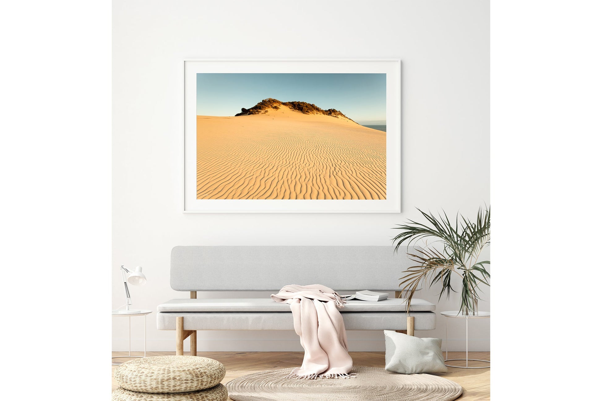 Rainbow Beach golden dunes print shown framed in white above a bench seat.