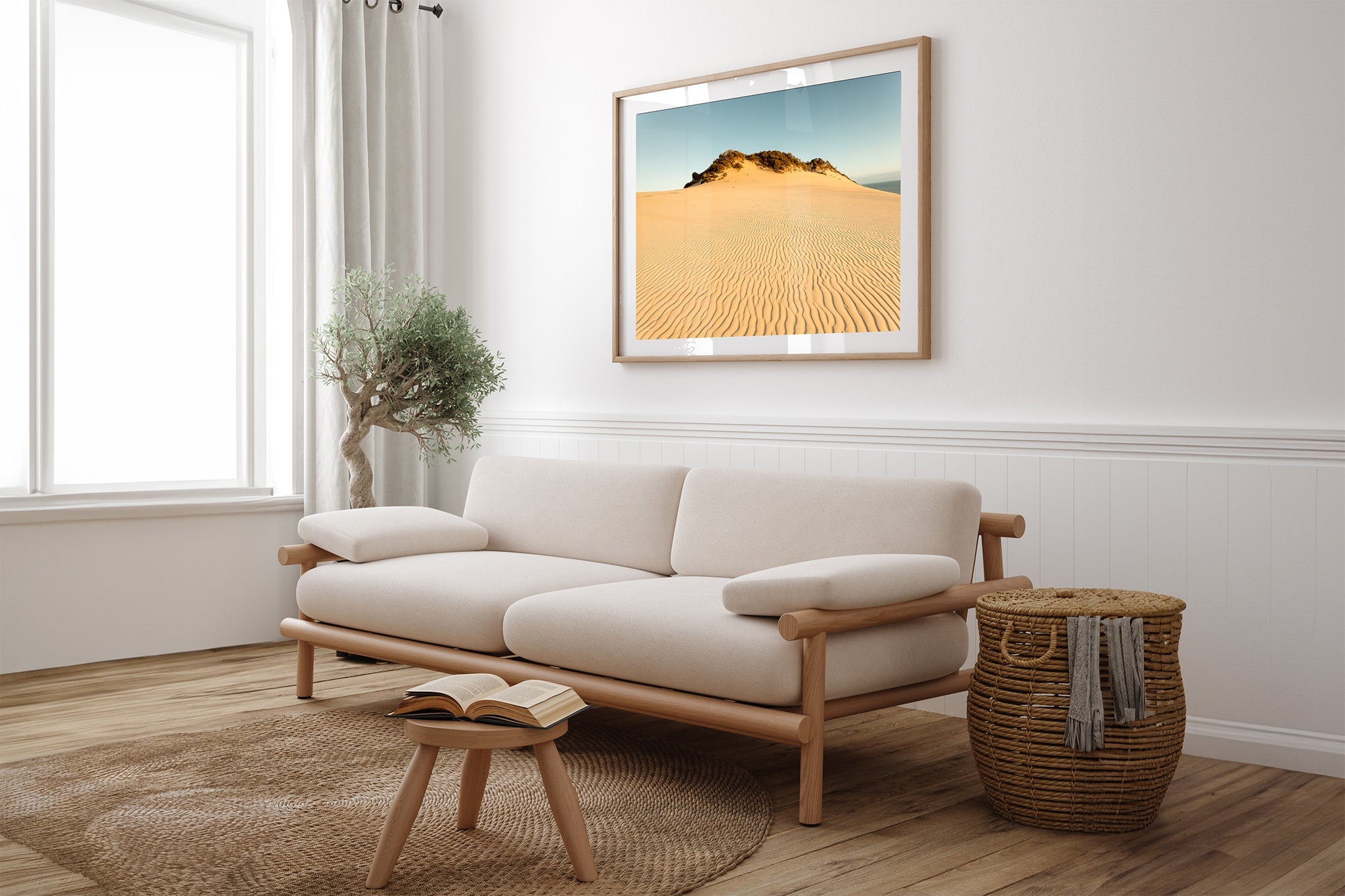 Rainbow Beach golden dunes print shown framed in oak above a couch.