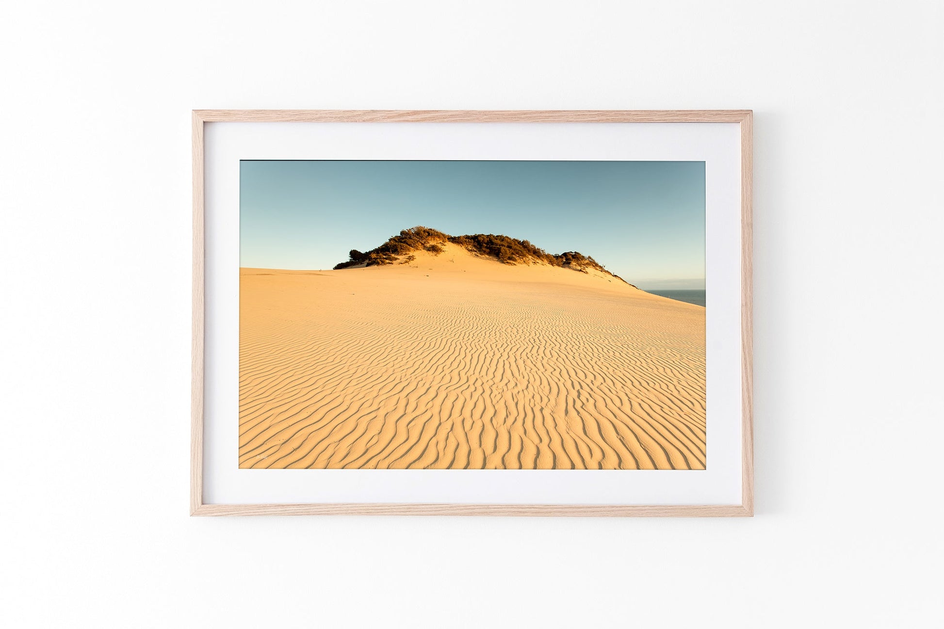 Rainbow Beach golden dunes print shown framed in oak.