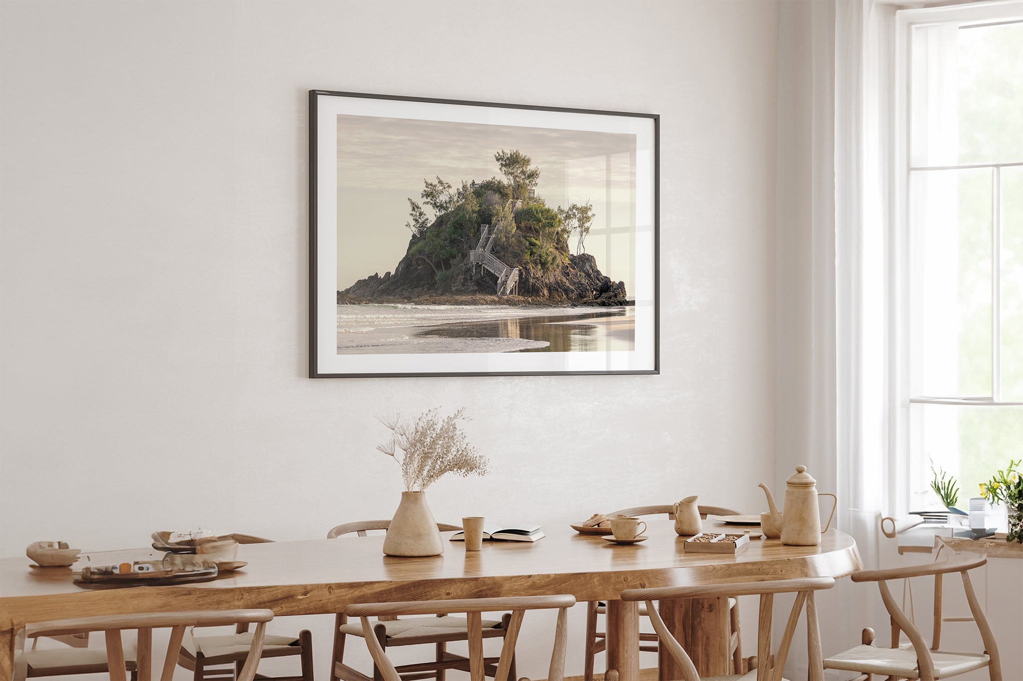 Golden Headland print shown framed in black above an oak table.