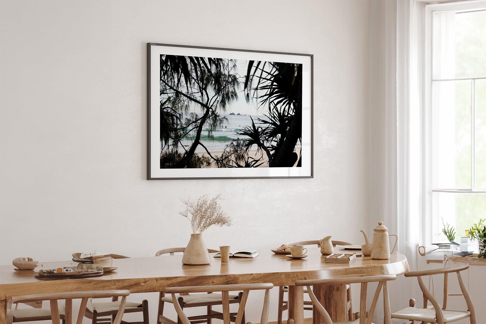 Framed Horizon print shown framed in black above an oak table.
