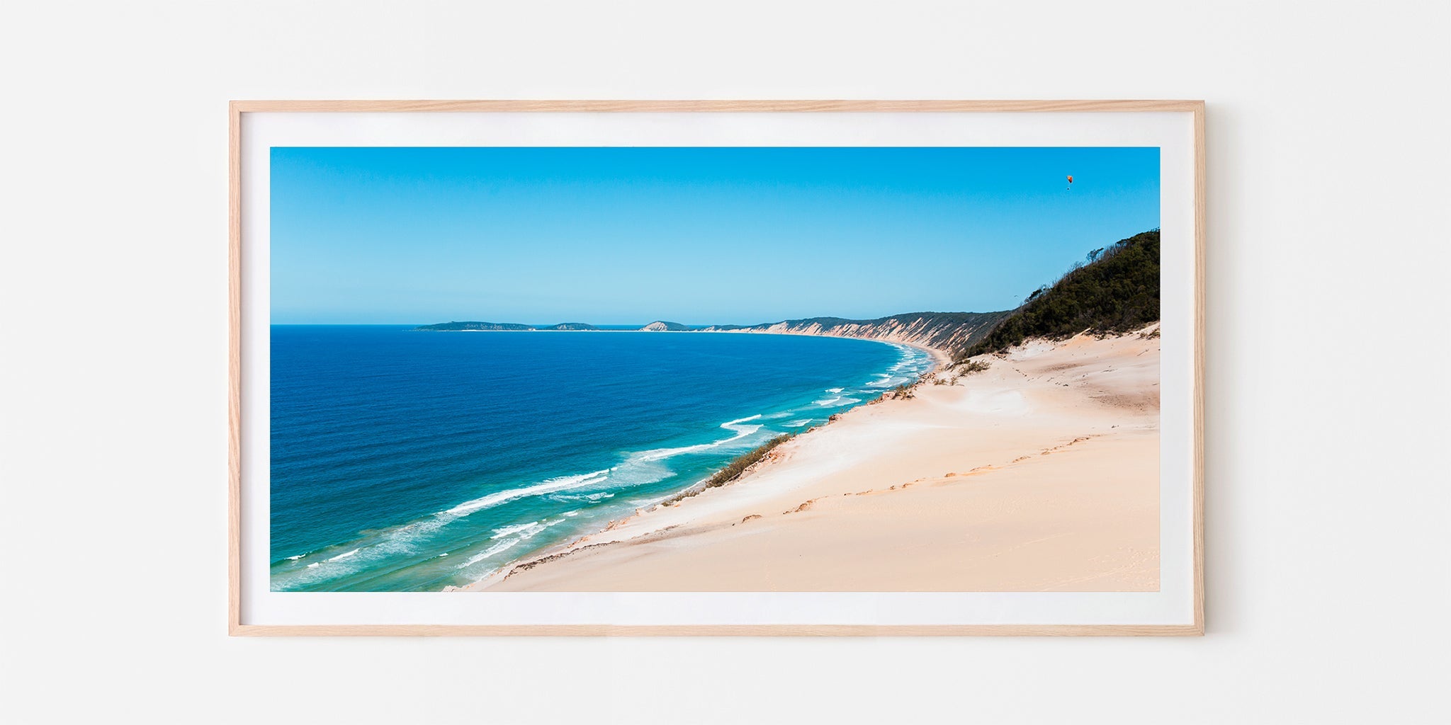 Rainbow Beach coloured sands print shown framed in oak.