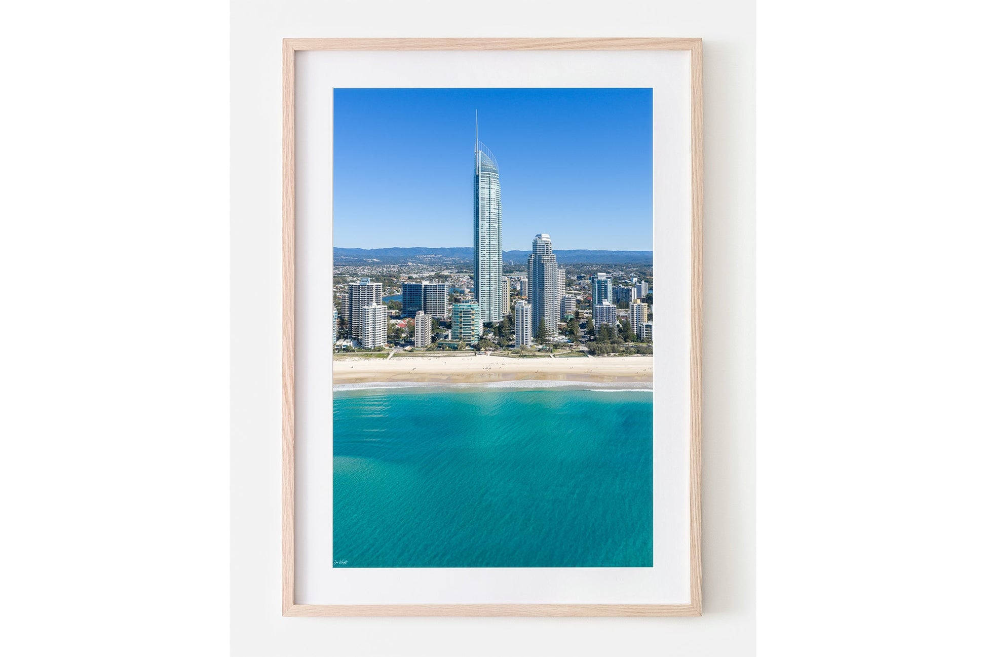 The Coastal Heights print shown framed in oak.