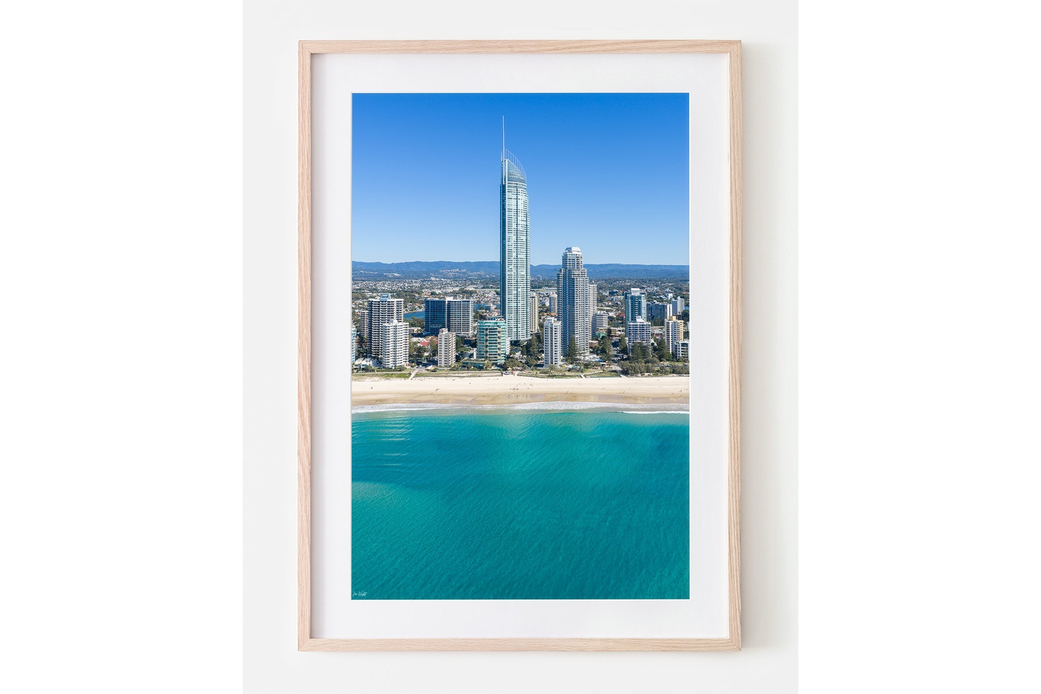 The Coastal Heights print shown framed in oak.