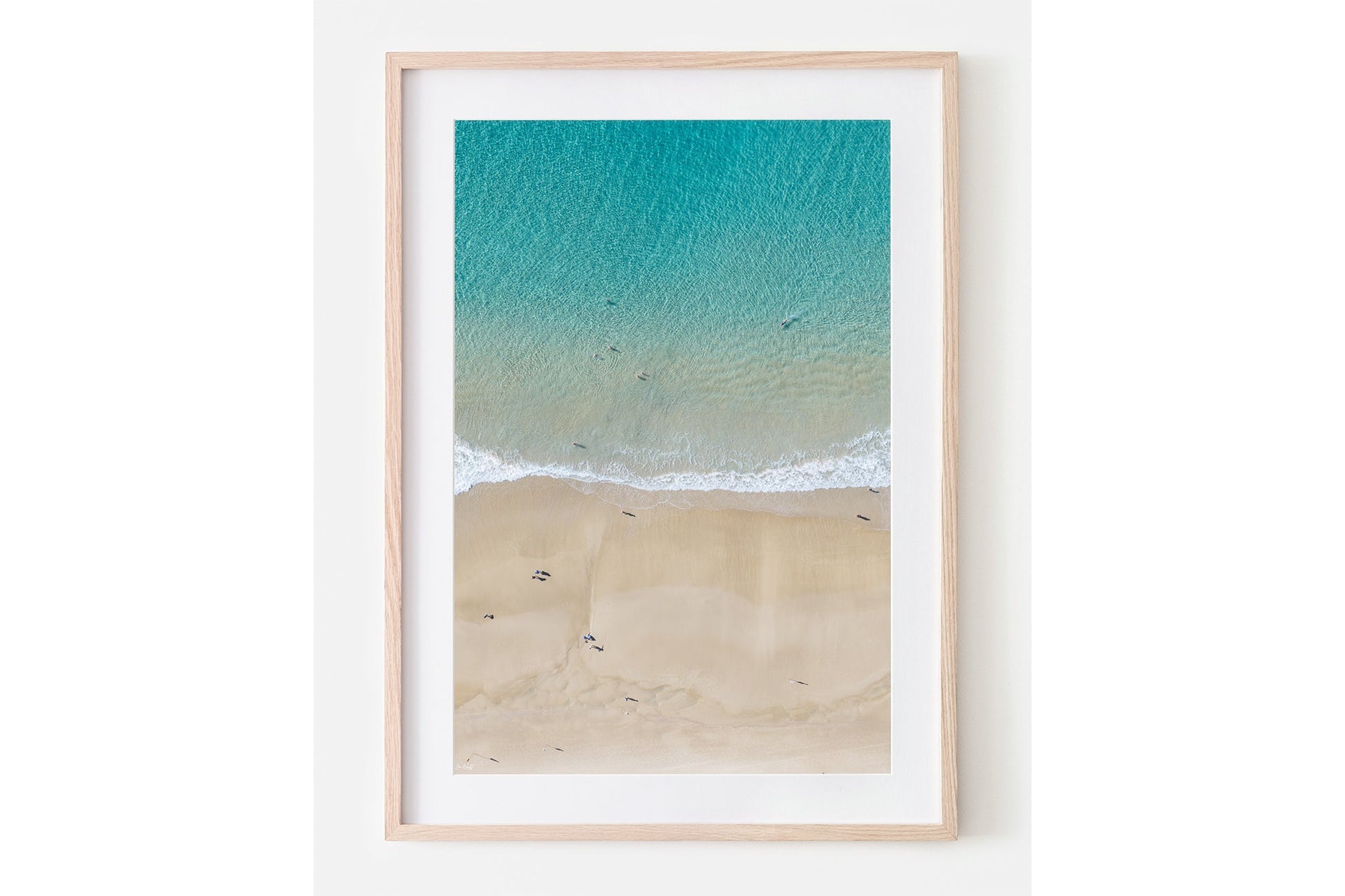 The Turquoise Shallows print shown framed in oak.