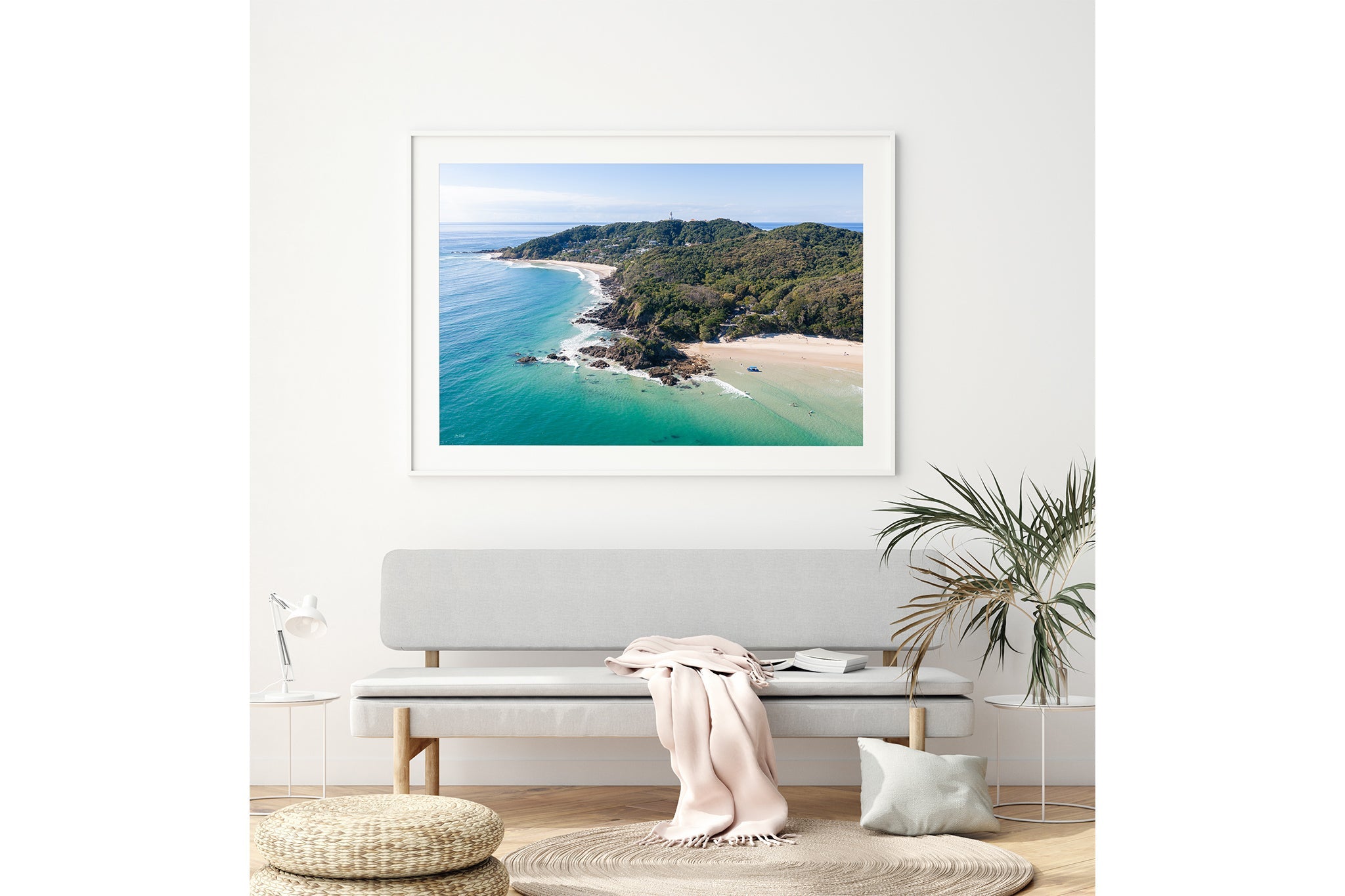Cape Byron aerial print shown framed in white above a bench seat.