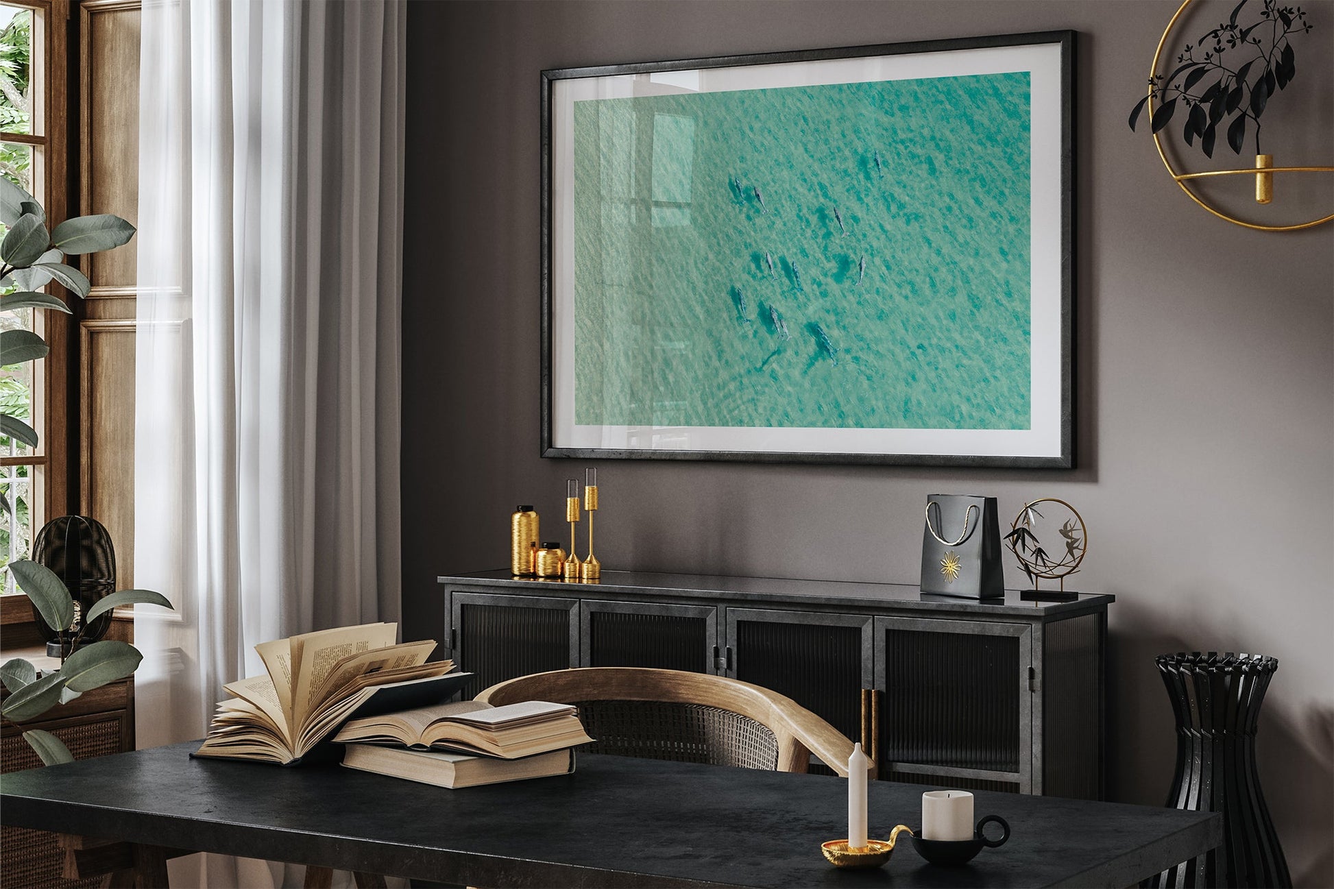 Moreton Bay dolphin pod print shown framed in black in a dark room.