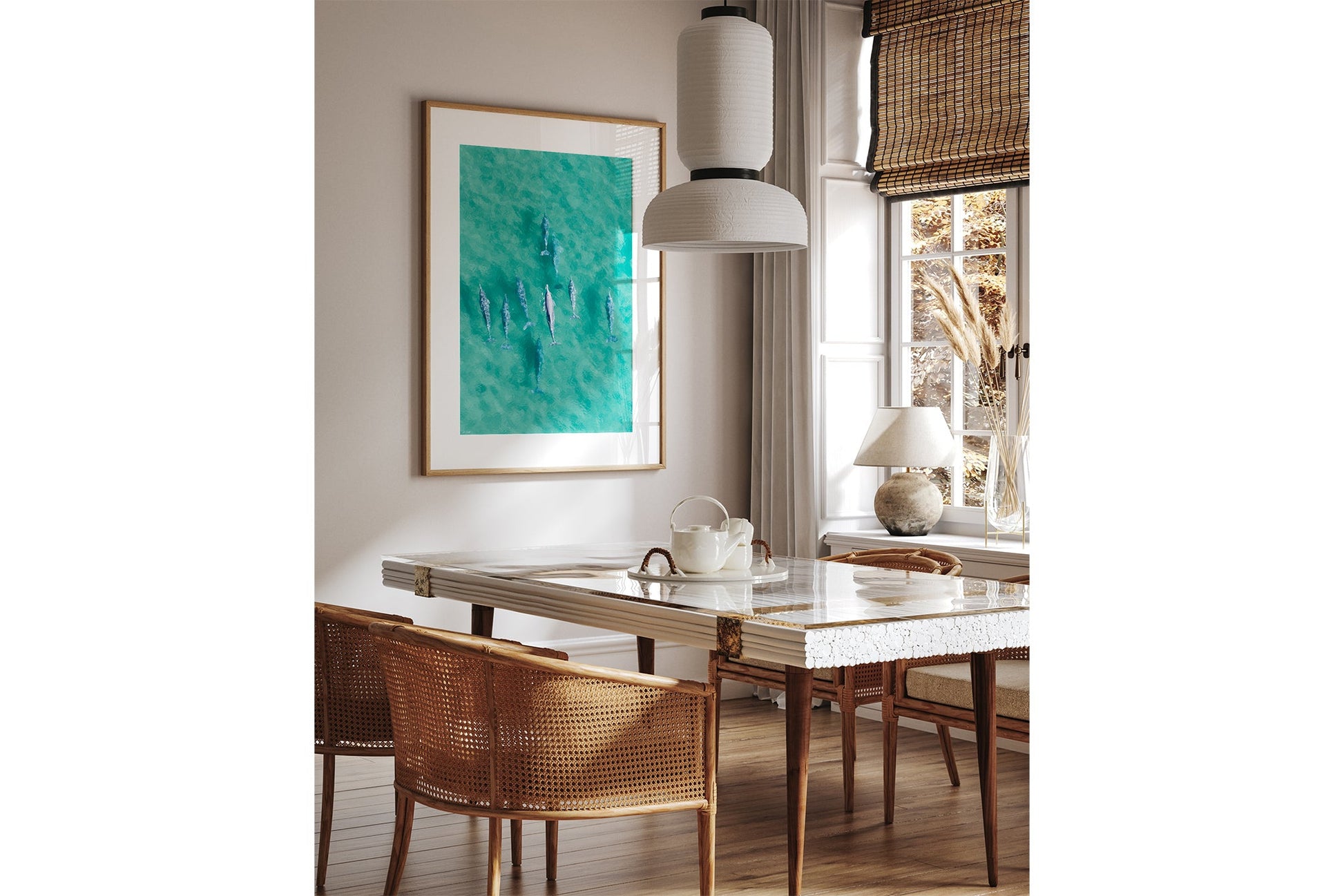 Moreton Bay dolphin print shown framed in oak above a dining table.