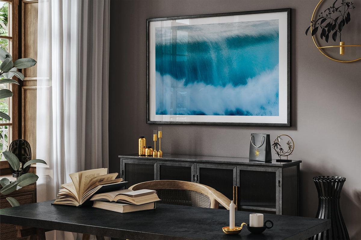 Deep Impact wave print shown framed in black in a dark room.