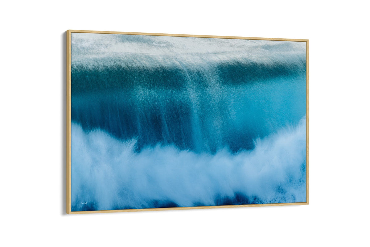 Deep Impact wave print shown as a canvas in an oak float frame.