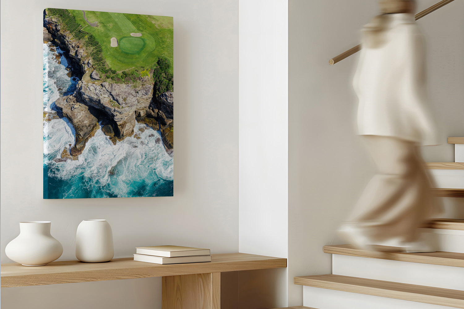 Canvas print of a coastal scene with a person walking up stairs in the background
