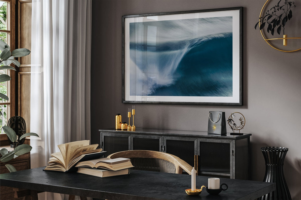 Impact Blur wave print shown framed in black in a dark room.