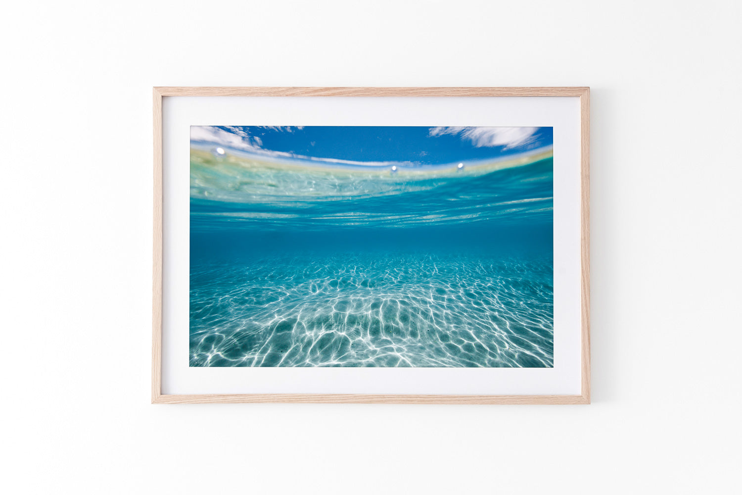 Coastal artwork and beach print in oak frame