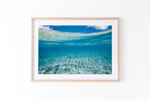 Coastal artwork and beach print in oak frame