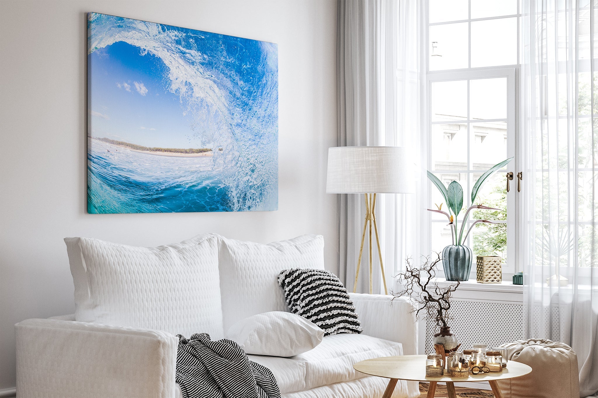 Blue barrel wave print shown as an unframed canvas, hung in a bright white living room.