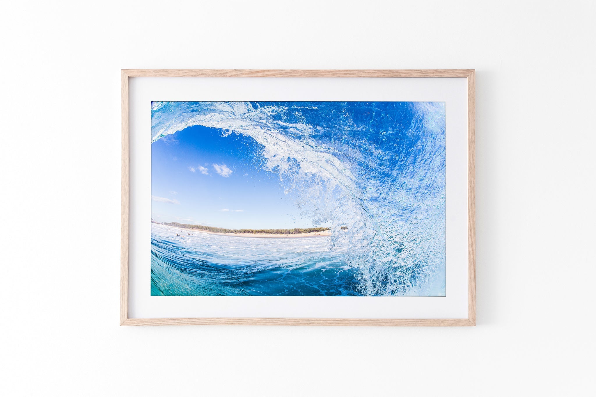 Blue barrel wave print shown framed in oak against a plain white studio background.