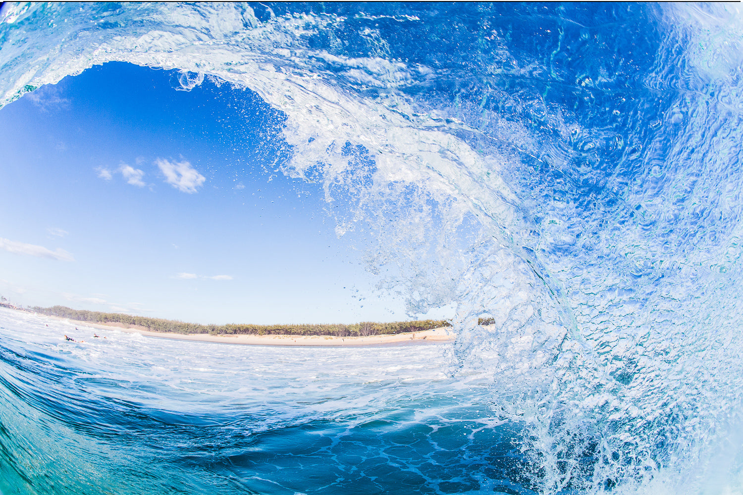 A wave barrel curling over glassy blue green water at South Stradbroke, sunlight glowing through the tube, wave art print.