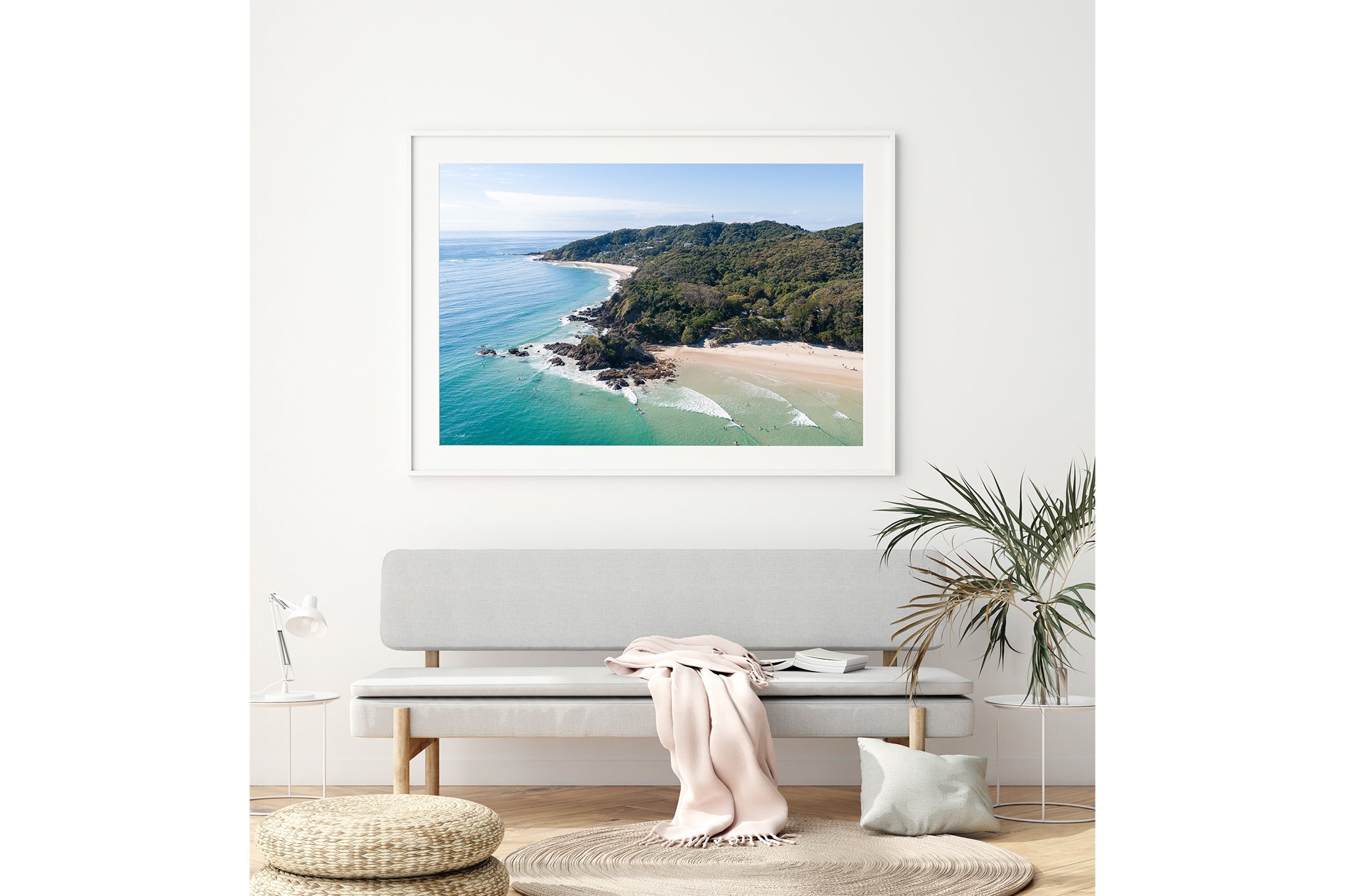 Lighthouse Point print shown framed in white above a bench seat.