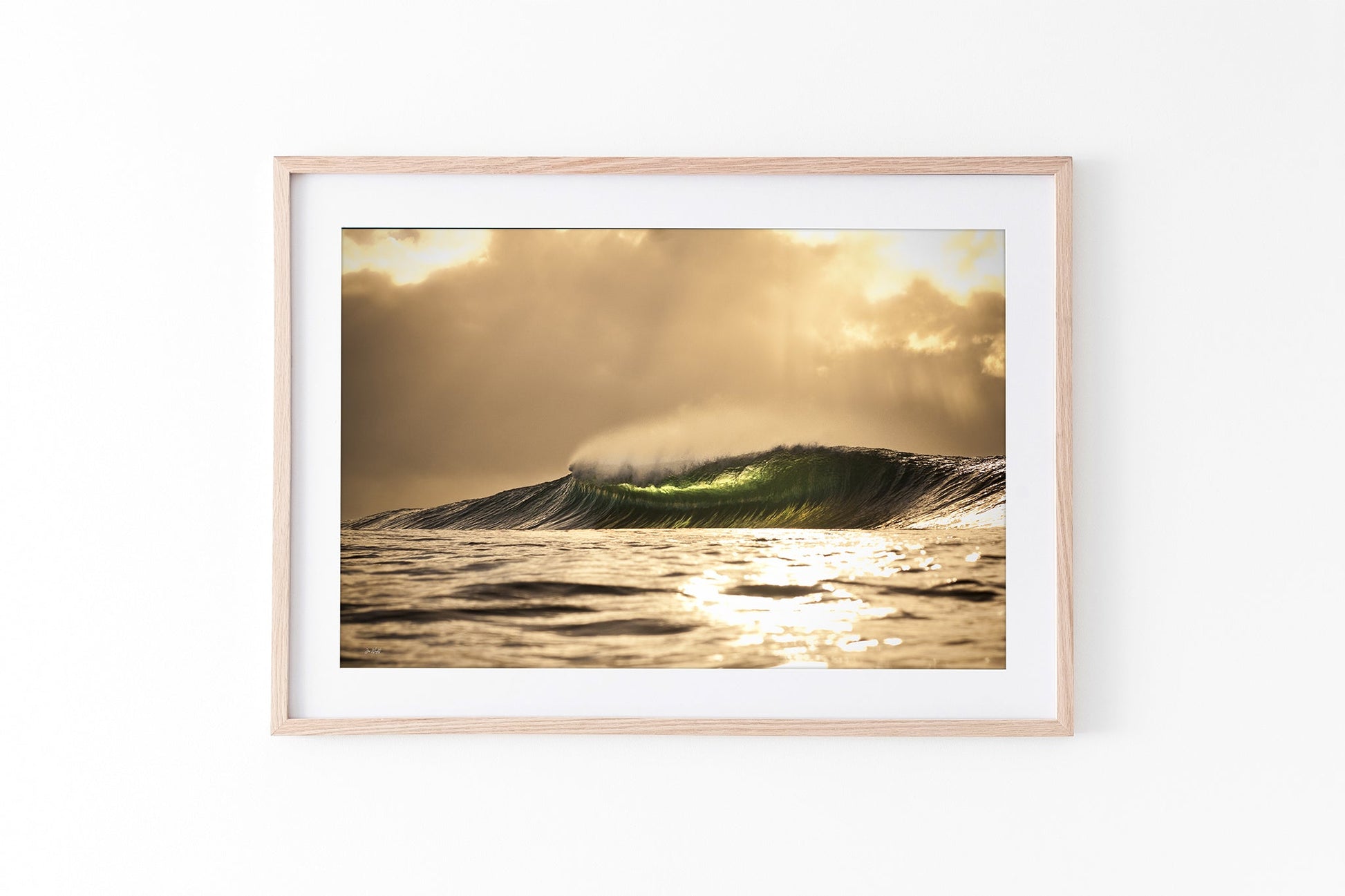 Golden sunset wave print shown framed in oak against a plain white studio background.