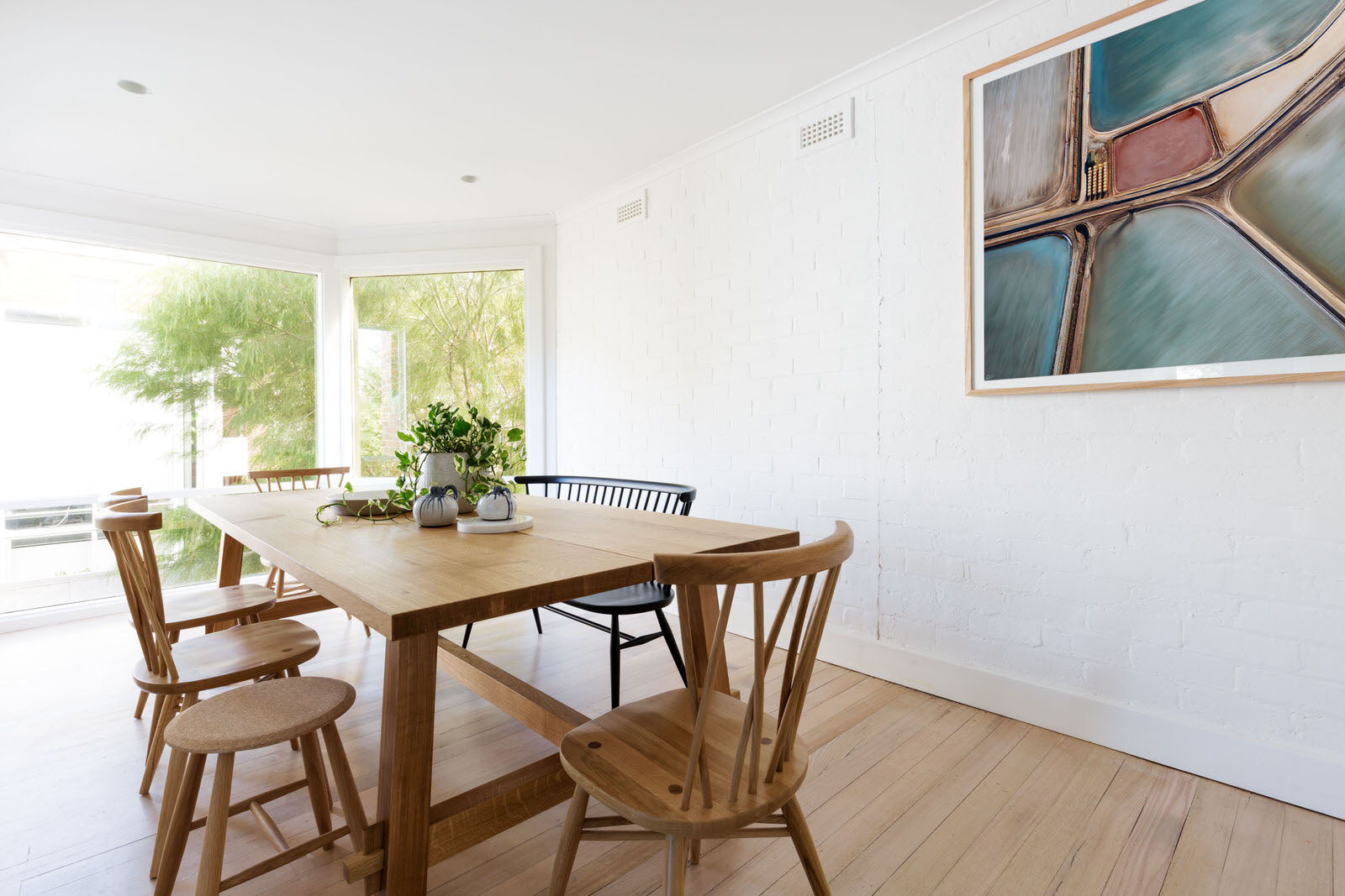 picture hanging on wall abstract art and couch with oak frame